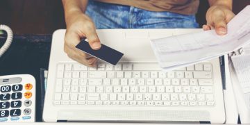 a person using a computer and learning how to Close a Bank Account.