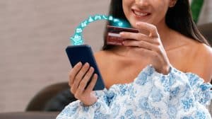 woman checking Credit Card Rewards Programs.