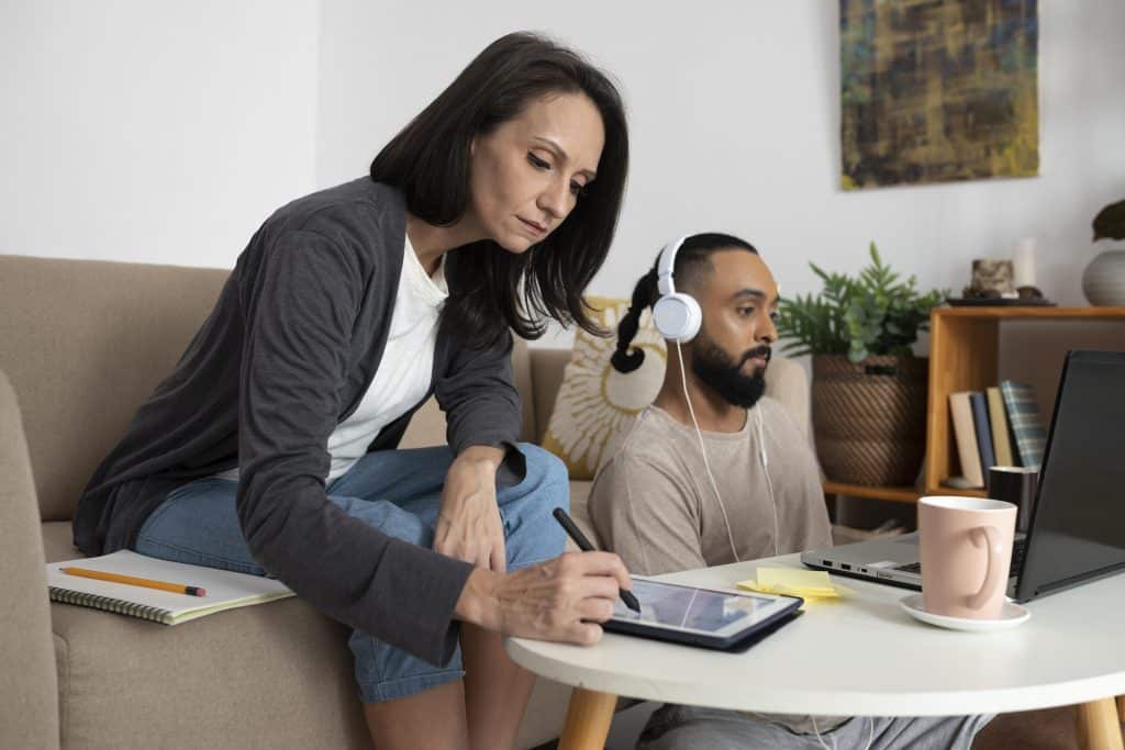 Young adults working remotely while managing their financial goals.